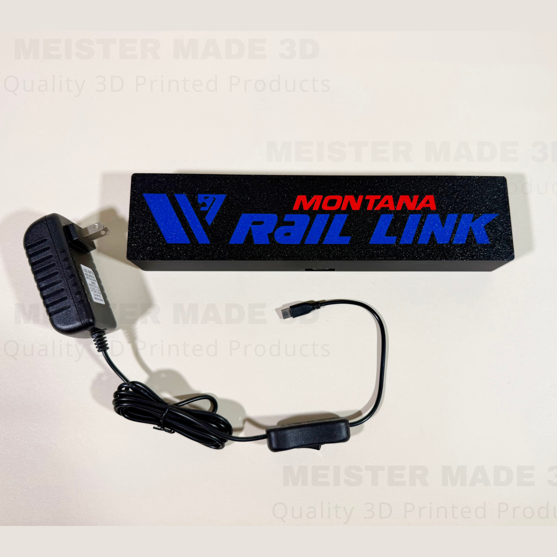 Front view of custom Montana Rail Link LED railroad sign with included power adapter and inline switch, 3D printed train room decor.