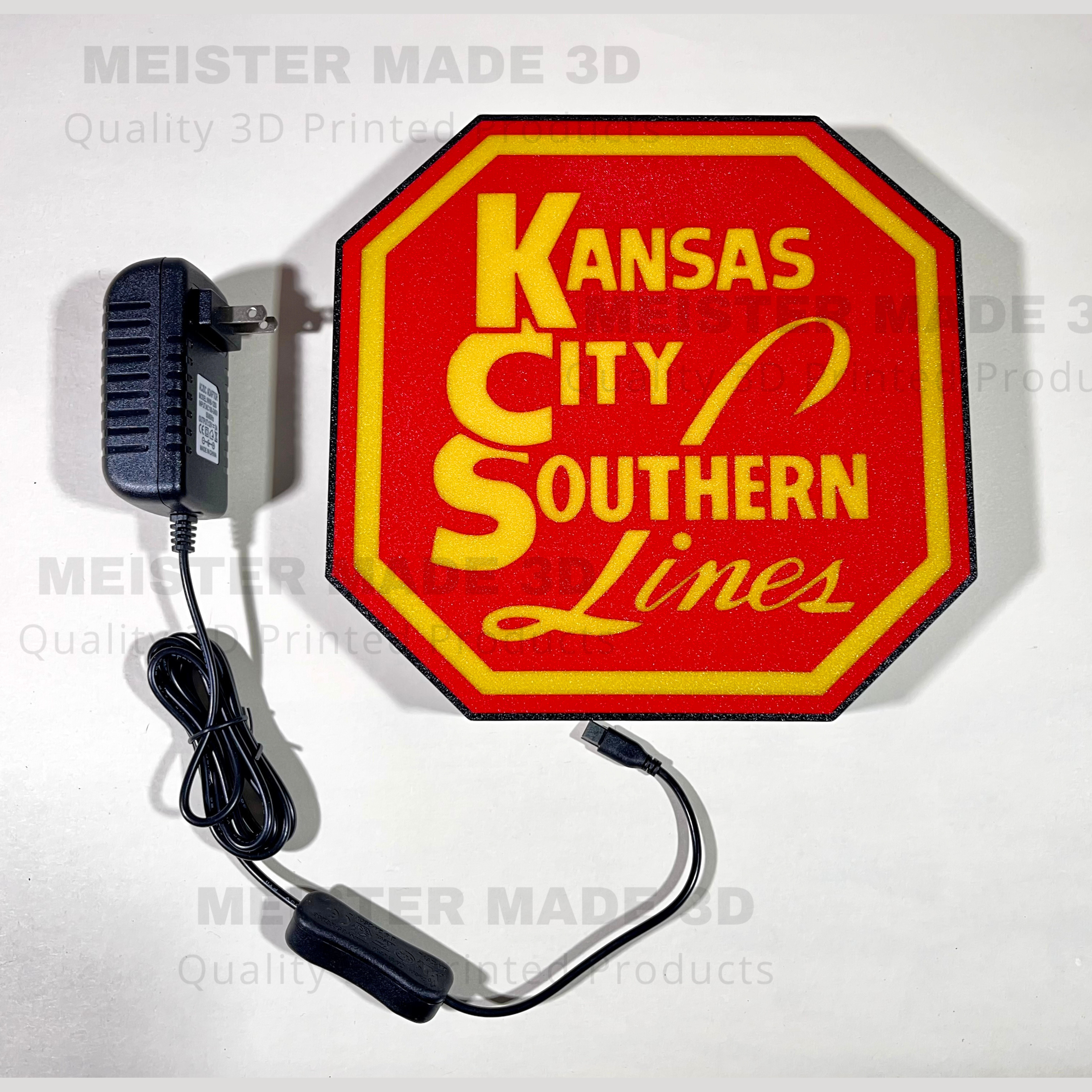 Kansas City Southern Lines sign with red background and yellow text on a white background