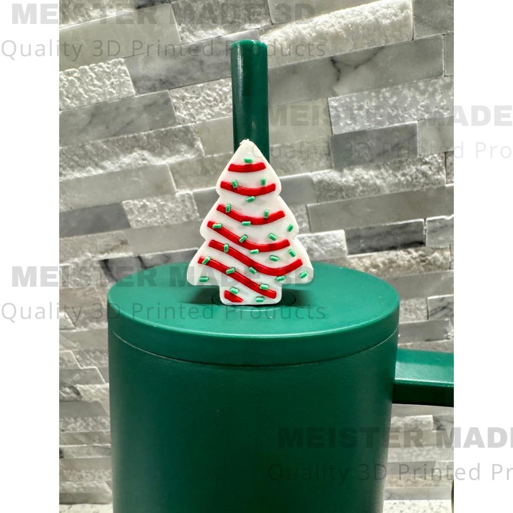 Green tumbler with a Little Debbie Christmas tree-themed straw buddy on a gray stone background