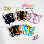 Butterfly-shaped fidget clicker keychains with colorful designs on a white background.