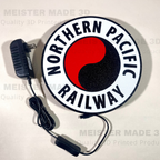 Circular sign with 'Northern Pacific Railway' logo and power adapter on a white background
