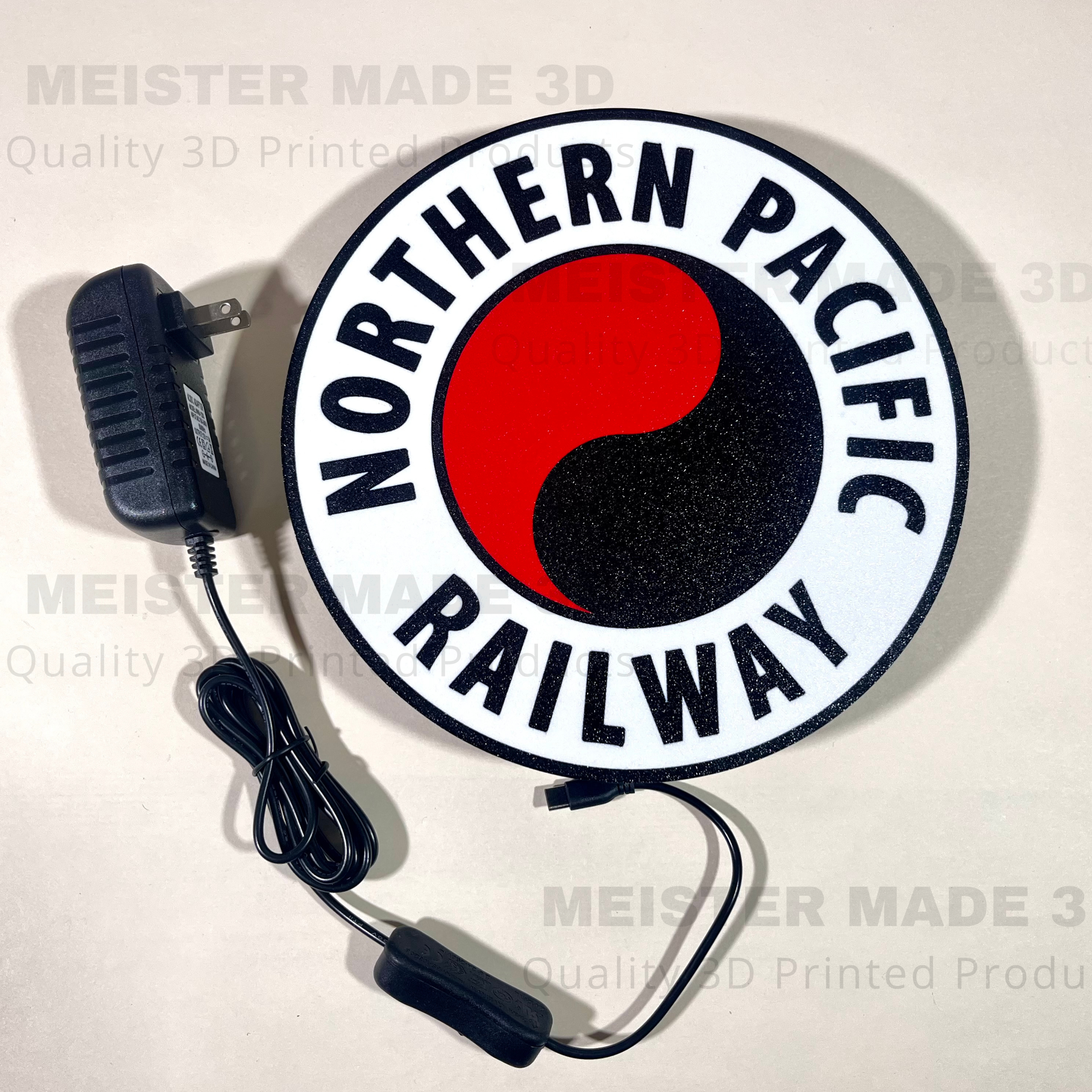 Circular sign with 'Northern Pacific Railway' logo and power adapter on a white background