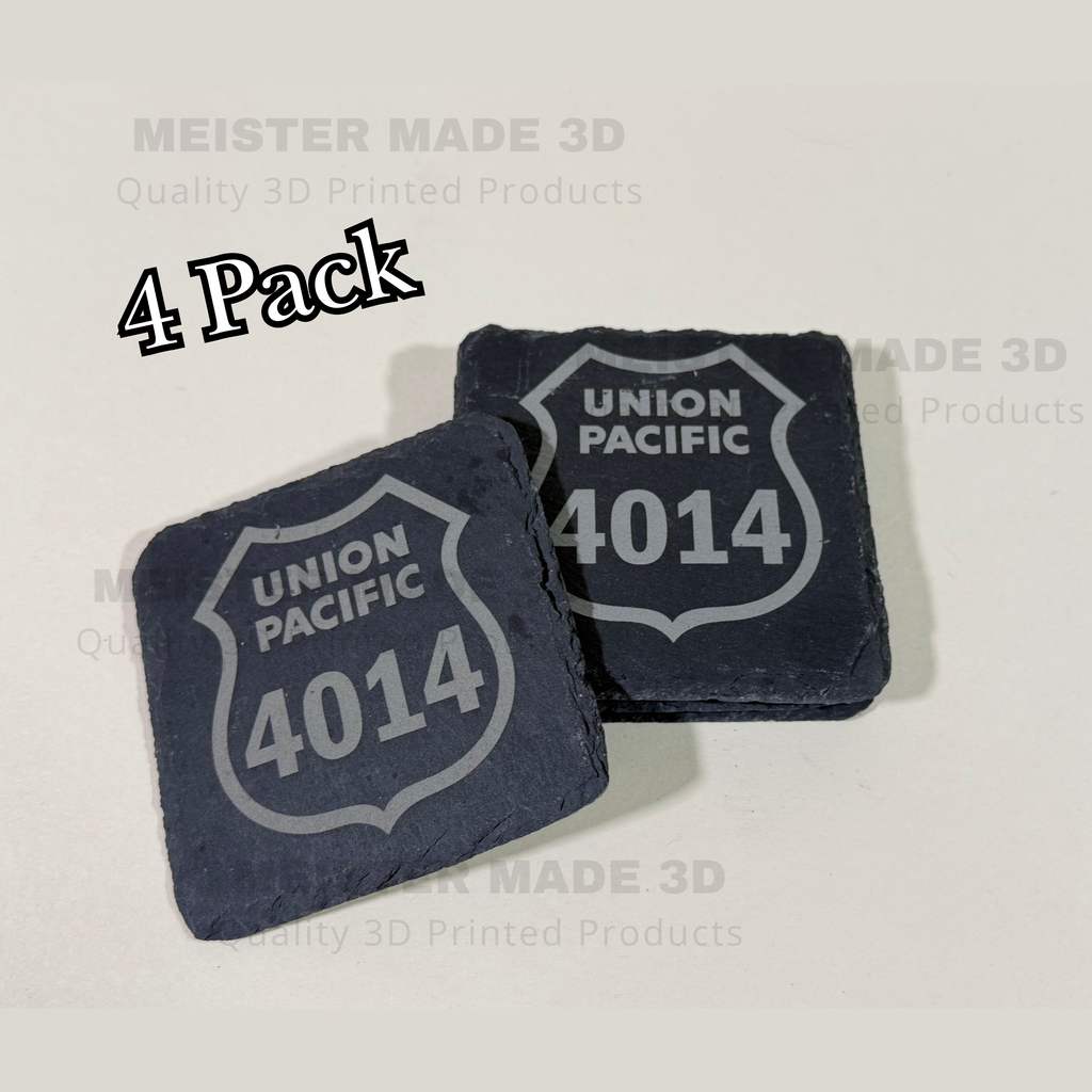 Two laser engraved Union Pacific 4014 shields on black slate coasters on  a tan background