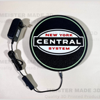Round sign with 'New York Central System' logo and power adapter on a white background