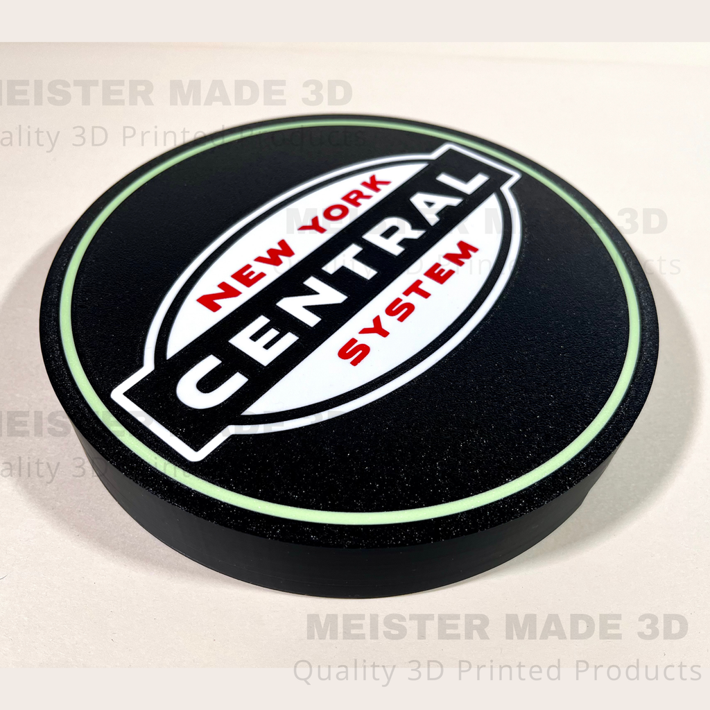 Round black sign with a light green outline and NYC New York Central System logo in the center.
