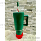 Green tumbler with a Little Debbie Christmas tree-themed straw buddy on a gray stone background