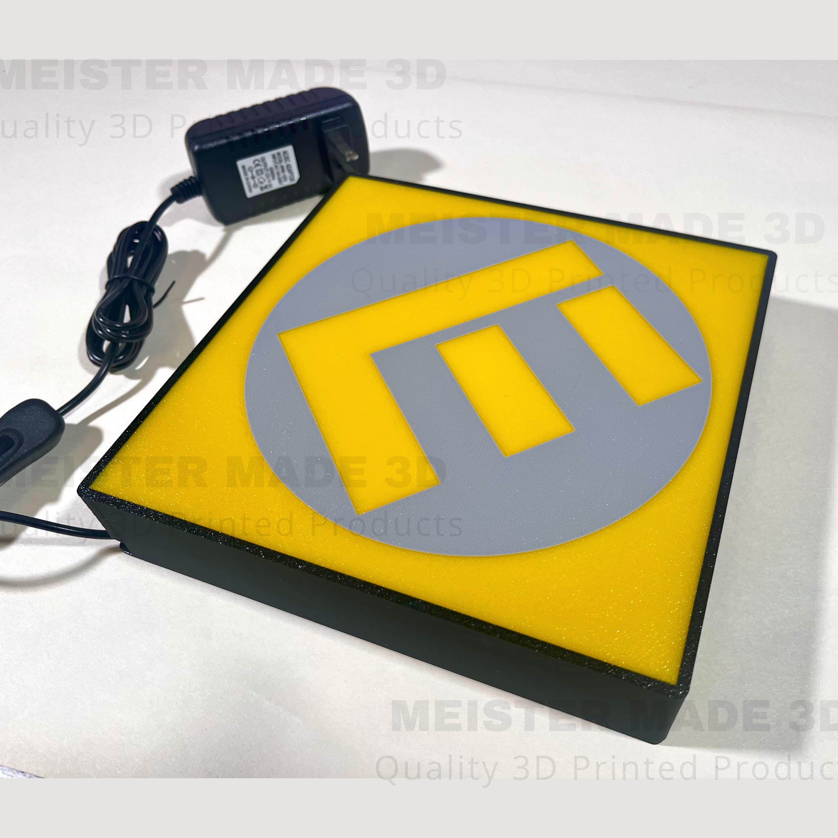 Yellow and gray sign with the letter E in the center.