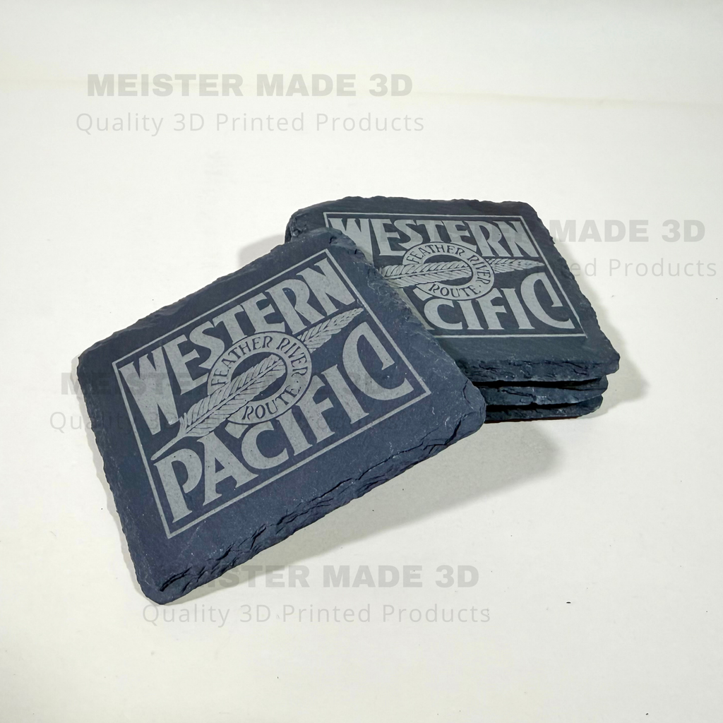 Two dark slate coasters stacked on a white surface, printed with a Western Pacific Railroad logo. The coasters have a rough, natural slate texture and are shown with a watermark overlay reading 'MEISTER MADE 3D Quality 3D Printed Products'.