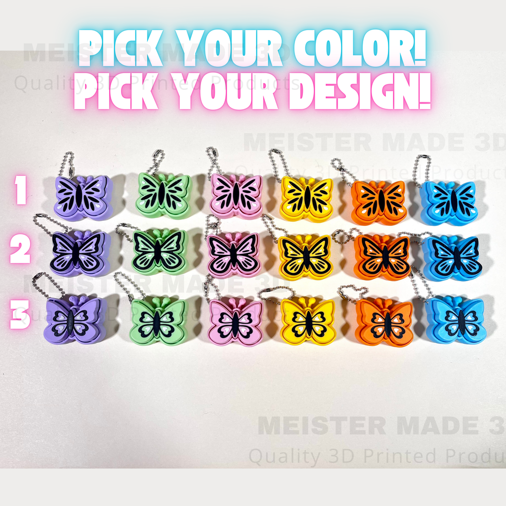 Butterfly keychains in various colors with text 'Pick your color! Pick your design!' on a white background.
