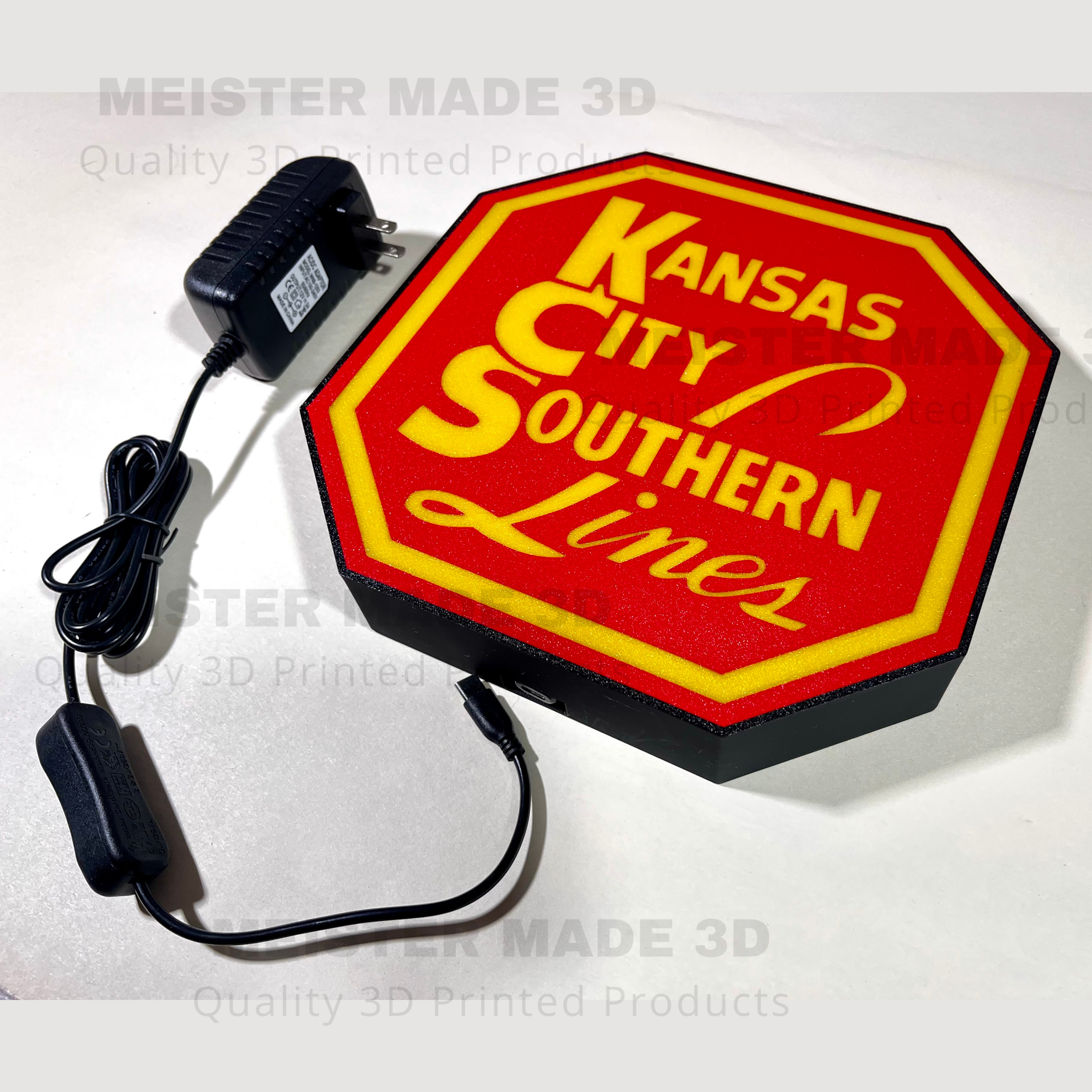 Red and yellow sign with 'Kansas City Southern Lines' text on a white background