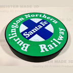 A circular 3D-printed sign featuring the Burlington Northern Santa Fe Railway logo, with a green outer ring, white lettering, a blue and white cross in the center, and a black raised edge, shown on a light beige background with faint watermarks.