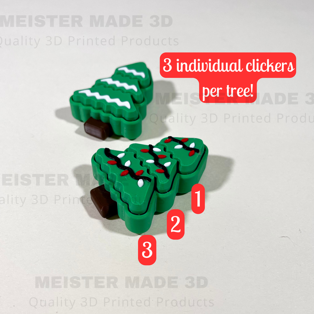 3D printed Christmas tree-shaped clickers with 'MEISTER MADE 3D' branding on a light gray background.