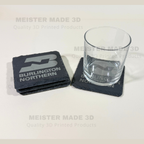 Laser engraved Burlington Northern slate coaster protecting a glass, demonstrating the coaster's size, durability, and railroad-themed design for home or office use.