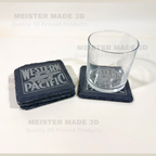 A set of dark slate coasters with a gray Western Pacific Railroad logo, shown with a clear glass on one coaster. The background is a clean white surface with light gray watermarks reading 'MEISTER MADE 3D Quality 3D Printed Products'.