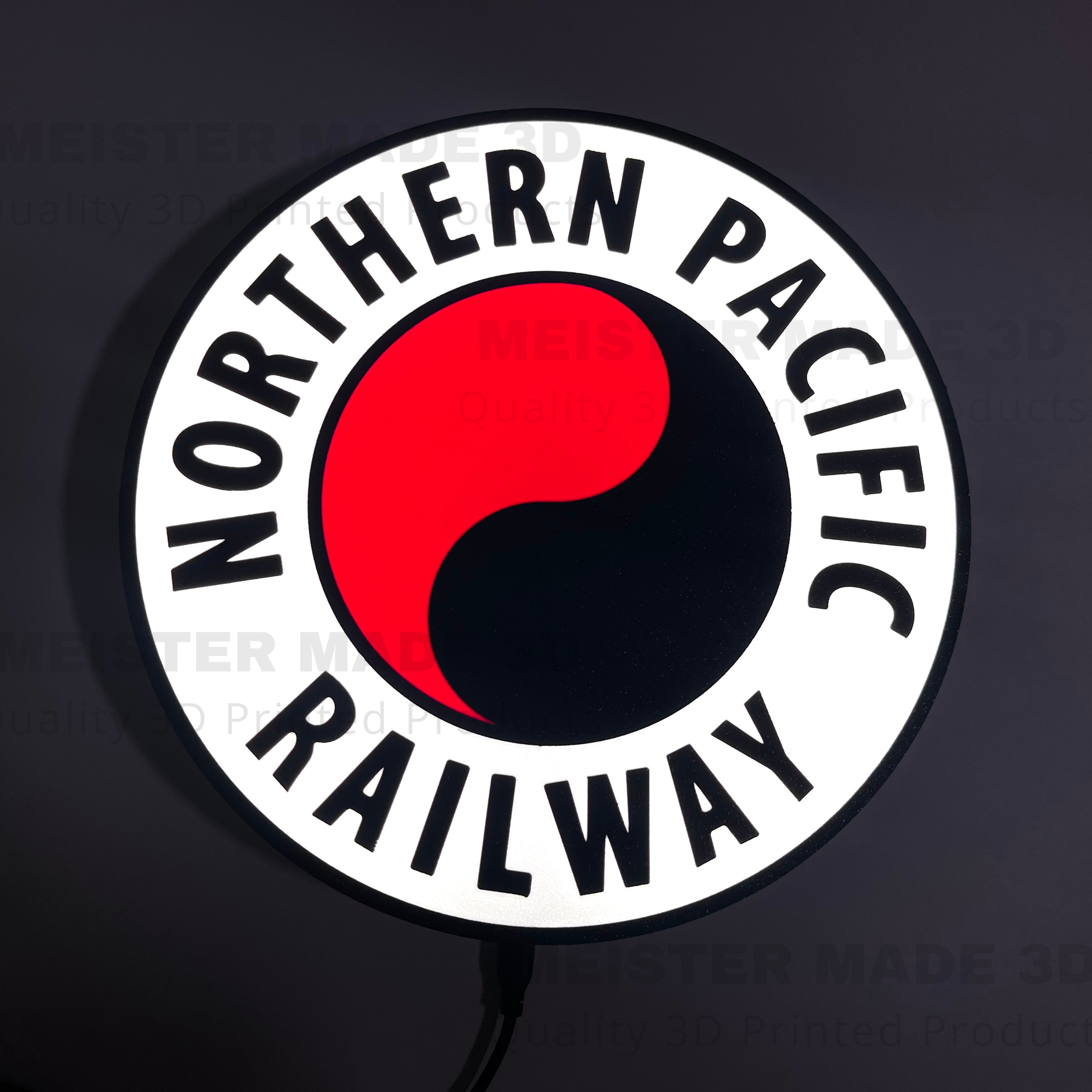 Illuminated Northern Pacific Railway logo with red and black design on a dark background