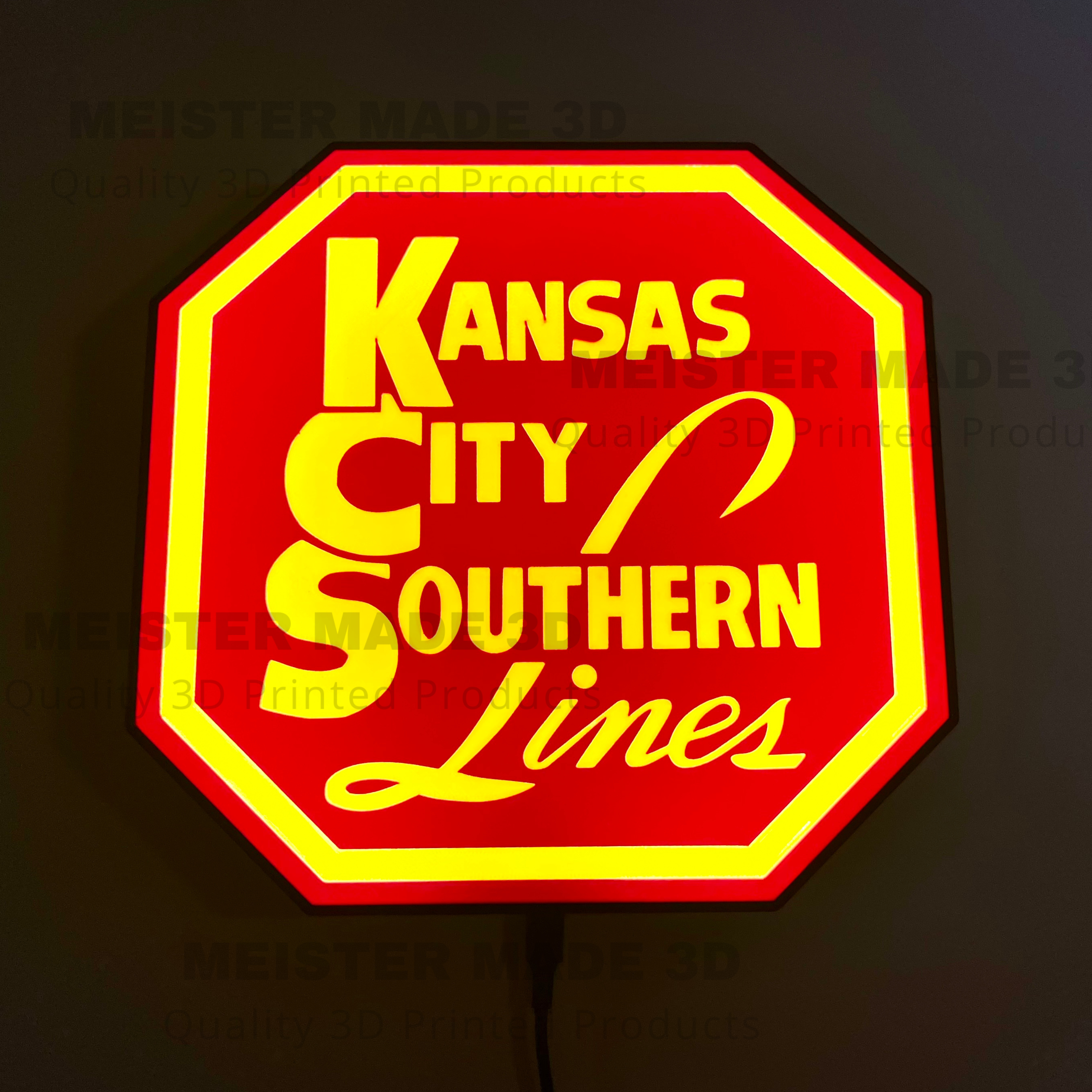 Illuminated Red and yellow sign with Kansas City Southern Lines' text on a dark background