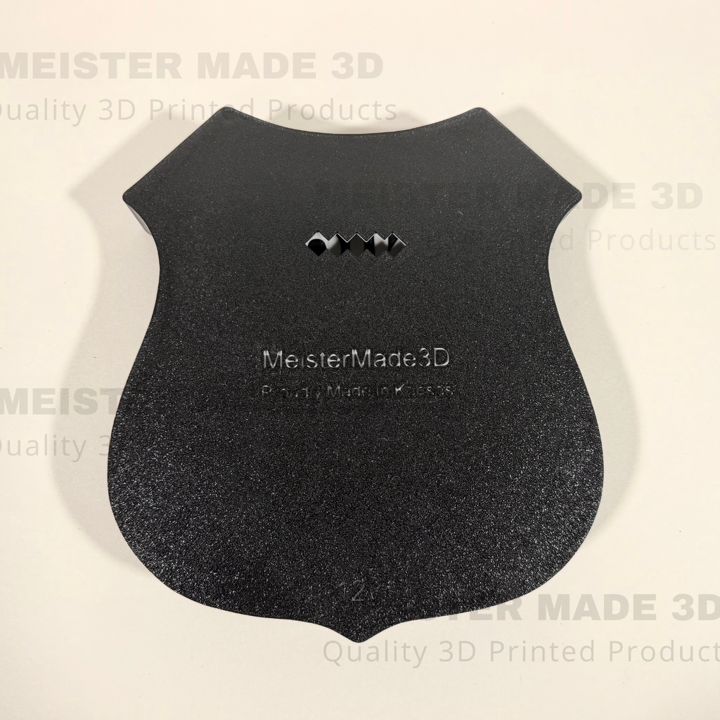 back side of shield sign showing adjustable mounting points. MeisterMade3D is embossed on the back