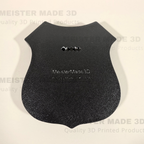 back side of shield sign showing adjustable mounting points. MeisterMade3D is embossed on the back