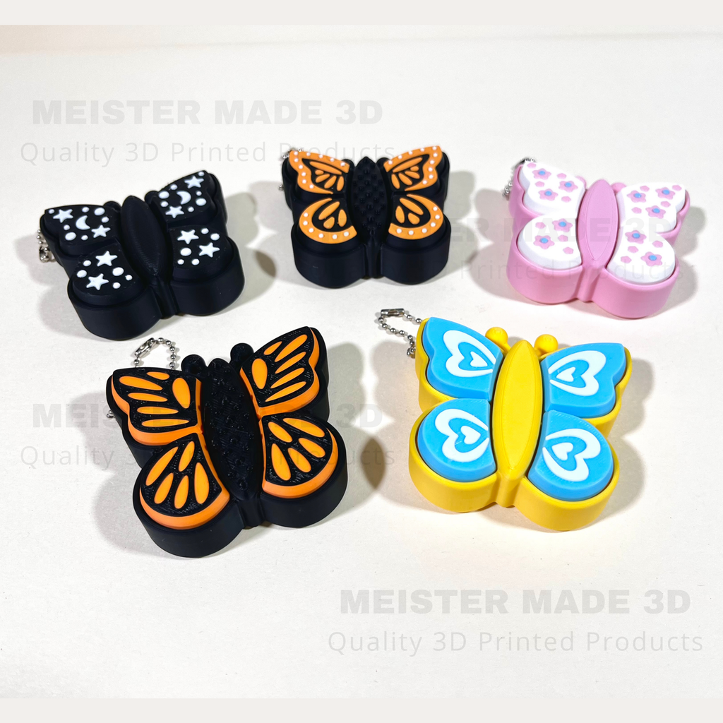 Butterfly-shaped keychains in various colors on a white background with 'MEISTER MADE 3D' branding.