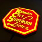 Illuminated Red and yellow sign with Kansas City Southern Lines' text on a dark background