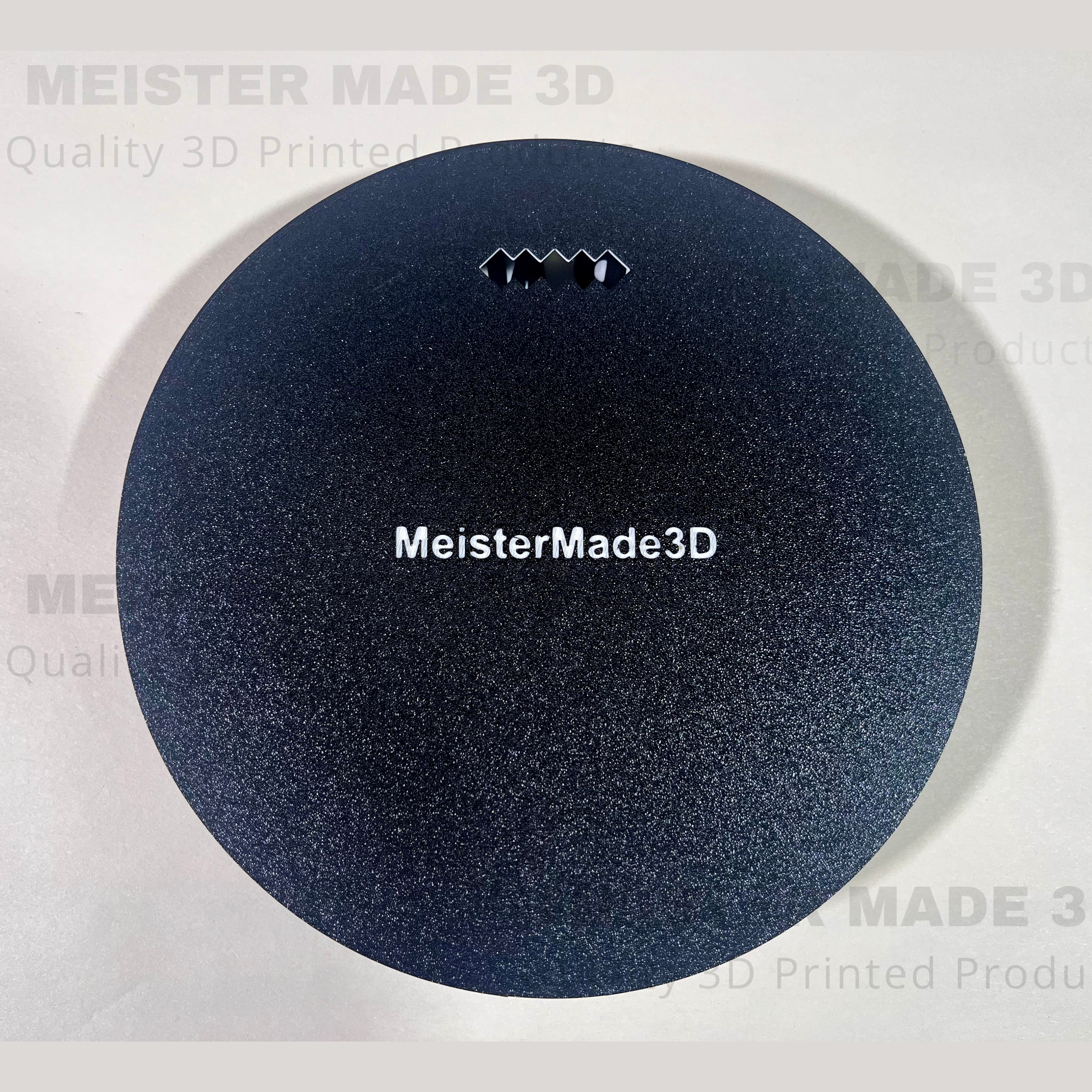 Back side of 3D printed sign displaying the mounting holes. MeisterMade3D text is in white embossed on the back of the sign.