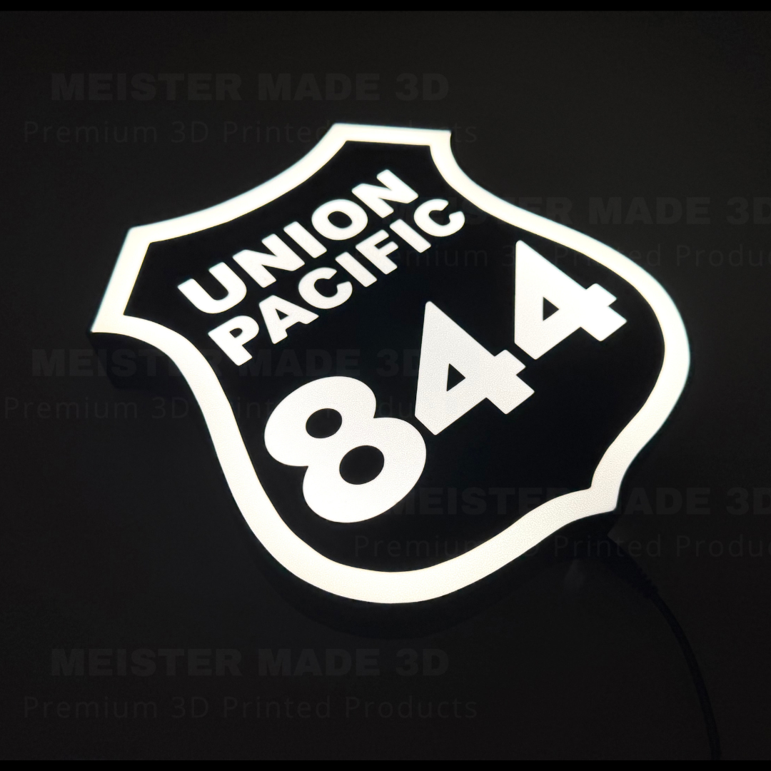 Angled illuminated Union Pacific 844 train sign displaying the classic railroad shield design with bright white LED lighting, ideal for railroad enthusiasts and train room decor.