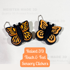 Butterfly-shaped sensory clickers with orange and black design on a white background, featuring raised 3d touch  & feel clickers