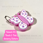 Butterfly-shaped sensory clicker with floral design on a light beige background. Featuring raised 3d touch  & feel clickers
