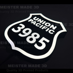 3D printed led illuminated 3985 shield sign on a dark background showing the sign illuminated