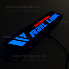 Close angled nighttime view of glowing Montana Rail Link railroad sign with bright LED illumination and modern train-inspired styling.