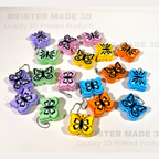 Colorful butterfly-shaped keychains on a white background with 'MEISTER MADE 3D' branding.