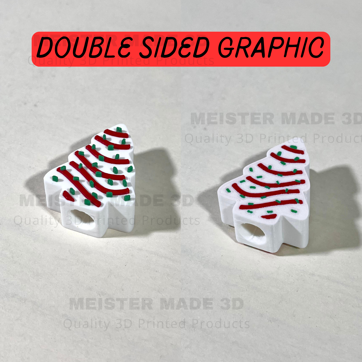3D-printed Christmas tree stanley straw buddies with red and green details on a light gray background, branded 'Meister Made 3D'. Double sided graphic on christmas trees.